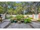 Back yard features a white fence, bricked flowerbed, and beautiful foliage at 1259 Oatland Lake Rd., Pawleys Island, SC 29585
