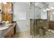 This beautiful bathroom boasts a glass surround shower, window and stone countertops at 1259 Oatland Lake Rd., Pawleys Island, SC 29585
