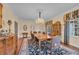 Spacious dining room has a large table and chairs with lots of light from the many windows at 1259 Oatland Lake Rd., Pawleys Island, SC 29585
