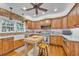 Kitchen boasts brick accents, custom cabinets, modern appliances, and a center island with seating at 1259 Oatland Lake Rd., Pawleys Island, SC 29585