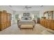 A spacious main bedroom is adorned with lovely windows, dressers and armoire at 1259 Oatland Lake Rd., Pawleys Island, SC 29585