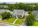 Aerial view of a home with a well-kept lawn, mature trees, and a community pool at 136 Southbury Dr., Myrtle Beach, SC 29588