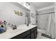 Modern bathroom featuring a double vanity, decorative mirror, and a shower with decorative tile at 136 Southbury Dr., Myrtle Beach, SC 29588