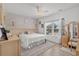 Bright bedroom featuring a queen bed, neutral color palette, and natural light from the windows at 136 Southbury Dr., Myrtle Beach, SC 29588