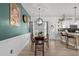 Open concept dining area leading into kitchen and back to the dining area with a green accent wall at 136 Southbury Dr., Myrtle Beach, SC 29588