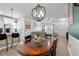 Spacious dining area with a wooden table, seating for four, open to living room and kitchen bar at 136 Southbury Dr., Myrtle Beach, SC 29588