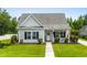 Charming single story home with manicured lawn, walkway, gray siding, black shutters, and cozy front porch at 136 Southbury Dr., Myrtle Beach, SC 29588