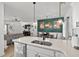 Kitchen island with sink, open to living room and dining area with views to a green accent wall at 136 Southbury Dr., Myrtle Beach, SC 29588