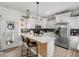 Modern kitchen featuring white cabinets, stainless steel appliances, and a stylish center island with seating at 136 Southbury Dr., Myrtle Beach, SC 29588