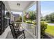 Inviting front porch featuring rocking chairs, white railings, and a view of the serene neighborhood street at 136 Southbury Dr., Myrtle Beach, SC 29588