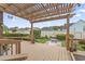 Back deck featuring an overhead pergola and a landscaped backyard at 1468 Fox Hollow Way, North Myrtle Beach, SC 29582