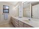 Bathroom with double sinks, a window, and a shower-tub combo at 1468 Fox Hollow Way, North Myrtle Beach, SC 29582