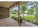 Relaxing covered porch with brick flooring and a view of the landscaped front yard and quiet street at 1468 Fox Hollow Way, North Myrtle Beach, SC 29582
