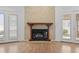 Close-up of the cozy fireplace with a dark wood mantel and decorative wall paneling at 1468 Fox Hollow Way, North Myrtle Beach, SC 29582