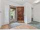 Inviting foyer with a wood front door and glass storm door, leading into a home with hardwood floors at 1468 Fox Hollow Way, North Myrtle Beach, SC 29582