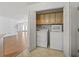 Convenient laundry room with overhead cabinets and full-size washer and dryer at 1468 Fox Hollow Way, North Myrtle Beach, SC 29582