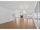 Bright living room featuring laminate flooring, a cozy fireplace, and modern chandelier at 1468 Fox Hollow Way, North Myrtle Beach, SC 29582
