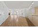 Spacious living room with hardwood floors and mirrors, illuminated by a chandelier and recessed lighting at 1468 Fox Hollow Way, North Myrtle Beach, SC 29582