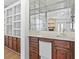 Wet bar with a mirrored backsplash, dark wood cabinets, and a small refrigerator at 1468 Fox Hollow Way, North Myrtle Beach, SC 29582