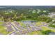 Stunning aerial view of a community, showcasing well-maintained homes, lush greenery, and serene pond at 1523 Wood Stork Dr., Conway, SC 29526