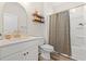 Bright bathroom featuring modern vanity with gold fixtures, decorative shelving, and shower tub combination at 1523 Wood Stork Dr., Conway, SC 29526