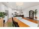 A dining area featuring wood floors and a view to the modern kitchen with a central island at 1523 Wood Stork Dr., Conway, SC 29526