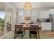 Bright dining area featuring a modern light fixture, slider door, and seating for four at 1523 Wood Stork Dr., Conway, SC 29526