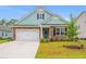 Charming single-Gathering home with stone and shake siding, manicured lawn and attached two-car garage at 1523 Wood Stork Dr., Conway, SC 29526
