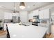 Well-appointed kitchen featuring white cabinets, stainless steel appliances, and a large island with seating at 1523 Wood Stork Dr., Conway, SC 29526