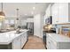 Bright kitchen featuring white cabinets, stainless steel appliances, and an island with a quartz countertop at 1523 Wood Stork Dr., Conway, SC 29526