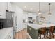 Spacious kitchen featuring white cabinets, stainless steel appliances, and an island with bar stool seating at 1523 Wood Stork Dr., Conway, SC 29526