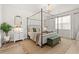 Spacious main bedroom with a canopy bed, side tables, and a well-lit window view at 1523 Wood Stork Dr., Conway, SC 29526