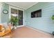 Cozy covered patio area with comfortable seating, outdoor TV, and stylish decor perfect for relaxation at 1523 Wood Stork Dr., Conway, SC 29526