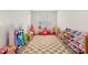 Spacious playroom with checkered rug, toy organizers, and ample space for creative play and storage at 1523 Wood Stork Dr., Conway, SC 29526