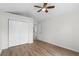 Bright bedroom features a ceiling fan, plank flooring, and a double door closet at 154 Cedar Point Ave., Murrells Inlet, SC 29576