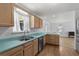 An open kitchen featuring stainless steel appliances, wood cabinets and sink with green countertops at 154 Cedar Point Ave., Murrells Inlet, SC 29576