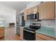 Bright kitchen featuring stainless steel appliances, wood cabinets, and a stainless steel refrigerator at 154 Cedar Point Ave., Murrells Inlet, SC 29576