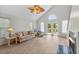 Bright living room featuring vaulted ceilings, fan, and a cozy floral sofa at 154 Cedar Point Ave., Murrells Inlet, SC 29576