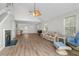 Bright living room with soaring ceilings, wood-look flooring, and a cozy fireplace at 154 Cedar Point Ave., Murrells Inlet, SC 29576