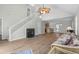 Open-concept living room with wood floors, staircase and fireplace at 154 Cedar Point Ave., Murrells Inlet, SC 29576