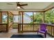 Relaxing screened porch with wood railings, ceiling fan, and a blue armchair at 154 Cedar Point Ave., Murrells Inlet, SC 29576