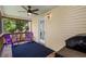 Relaxing screened porch with ceiling fan, outdoor lighting, and matching purple Adirondack chairs at 154 Cedar Point Ave., Murrells Inlet, SC 29576
