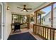 Inviting screened porch with ceiling fan, wood railings, and a barbecue grill at 154 Cedar Point Ave., Murrells Inlet, SC 29576