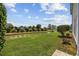 Landscaped backyard with a canal view, mature trees, and lush green lawn at 141 Lazy Willow Ln. # 103, Myrtle Beach, SC 29577