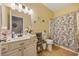 Well-lit bathroom with a vanity, toilet, and shower-tub combo at 141 Lazy Willow Ln. # 103, Myrtle Beach, SC 29577