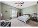 Comfortable bedroom featuring a ceiling fan and a large window for natural light at 141 Lazy Willow Ln. # 103, Myrtle Beach, SC 29577
