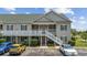 Charming two-story condo with balconies and well-maintained landscaping and convenient parking at 141 Lazy Willow Ln. # 103, Myrtle Beach, SC 29577