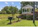 A grill and gazebo are set amongst lush greenery and a serene pond making a perfect area for outdoor entertaining at 141 Lazy Willow Ln. # 103, Myrtle Beach, SC 29577