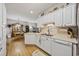 Bright kitchen with white cabinets, modern appliances, and a view to dining area at 141 Lazy Willow Ln. # 103, Myrtle Beach, SC 29577