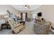 Cozy living room featuring plush seating, a ceiling fan, and neutral tones at 141 Lazy Willow Ln. # 103, Myrtle Beach, SC 29577